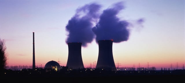 Two large cylindrical storage tanks pictured with with sunrise